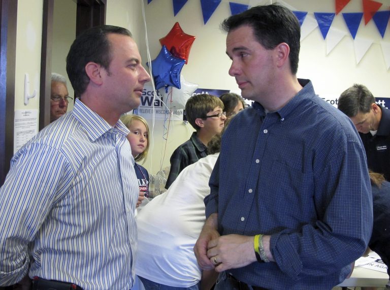 Wisconsin Gov. Scott Walker, right, talks with Republican National Committee Chairman Reince Priebus at a Republican campaign office in Germantown, Wis., on Sunday, June 3, 2012. (AP File)