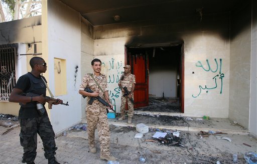Libyan military guards check one of the burnt out buildings at the U.S. Consulate in Benghazi, Libya, Friday, Sept. 14, 2012. American ambassador, Chris Stevens and three other Americans died there three days earlier when a mob of protesters and gunmen overwhelmed the compound. (AP Photo/Mohammad Hannon)