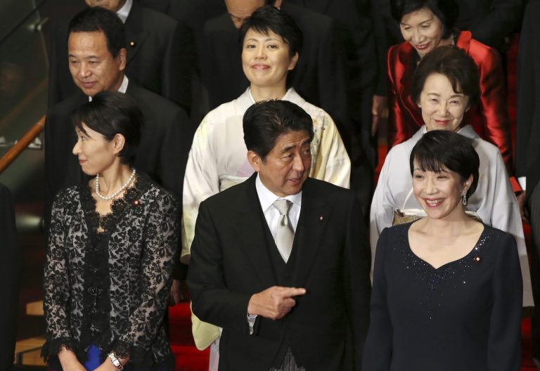 Japan's Prime Minister Shinzo Abe, front row center, and his new Cabinet members pose for a group photo following the first Cabinet meeting at the prime minister's official residence in Tokyo Wednesday, Sept. 3, 2014. The ministers from right in front row, are Internal Affairs Minister Sanae Takaichi, Abe, Trade Minister Yuko Obuchi, from right in second row, Minister in charge of Japanese Abducted by North Korea Eriko Yamatani, Minister in charge of Promoting Women Haruko Arimura, Minister in charge of Economic Revitalization Akira Amari. At right top is Justice Minister Midori Matsushima.  (AP Photo/Eugene Hoshiko)