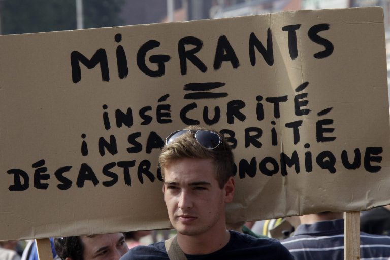 A man hold a banner which reads 