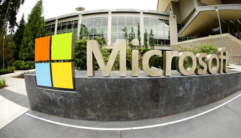 FILE - This July 3, 2014 file photo taken with a fisheye lens shows Microsoft Corp. signage outside the Microsoft Visitor Center in Redmond, Wash. Microsoft will acquire Stockholm-based game maker Mojang, the maker of the popular game Minecraft for $2.5 billion, the company announced Monday, Sept. 15, 2014. (AP Photo Ted S. Warren, File)