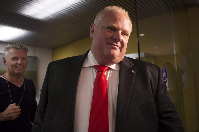 FILE- In a July 9, 2014 file photo Toronto Mayor Rob Ford leaves his office at city hall  in Toronto to take part in a vote. Health officials Wednesday Sept. 9, 2014, say Toronto Mayor Rob Ford has been admitted to a hospital and is believed to have a tumor.  (AP Photo/The Canadian Press, Chris Young, file)