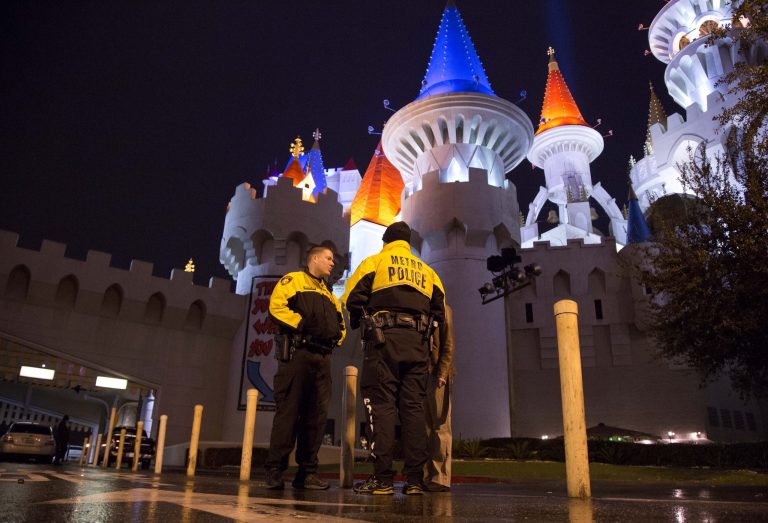   Las Vegas Metro Police officers stand watch outside the entrance to the Excalibur hotel-casino after a shooting near the registration desk left two dead, Friday, Dec. 14, 2012, in Las Vegas. At around 8:30 p.m., a man shot a woman, who was a vendor at the hotel's concierge desk, and then turned the gun on himself. The man was found dead at the scene. The woman was transported to a local hospital, where she was pronounced dead.(AP Photo/Julie Jacobson)  