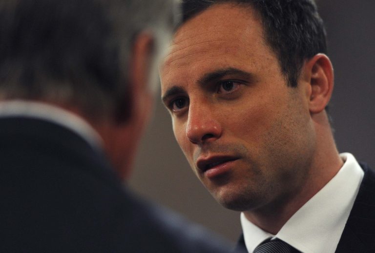 Oscar Pistorius pauses in court as his murder trial resumes, in Pretoria, South Africa, Thursday, Aug. 7 2014. The chief prosecutor in Oscar Pistorius' murder trial said Thursday the double-amputee athlete's lawyers have floated more than one theory in a dishonest attempt to defend against a murder charge for his killing of girlfriend Reeva Steenkamp. (AP Photo/Werner Beukes, Pool)