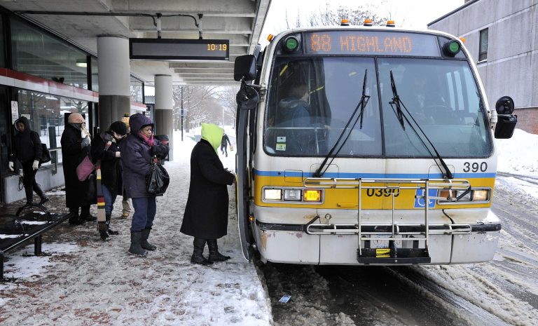 Passengers board a bus outside the MBTA subway stop in Davis Square in Somerville, Mass., Tuesday, Feb. 10, 2015. (AP Photo/Josh Reynolds)