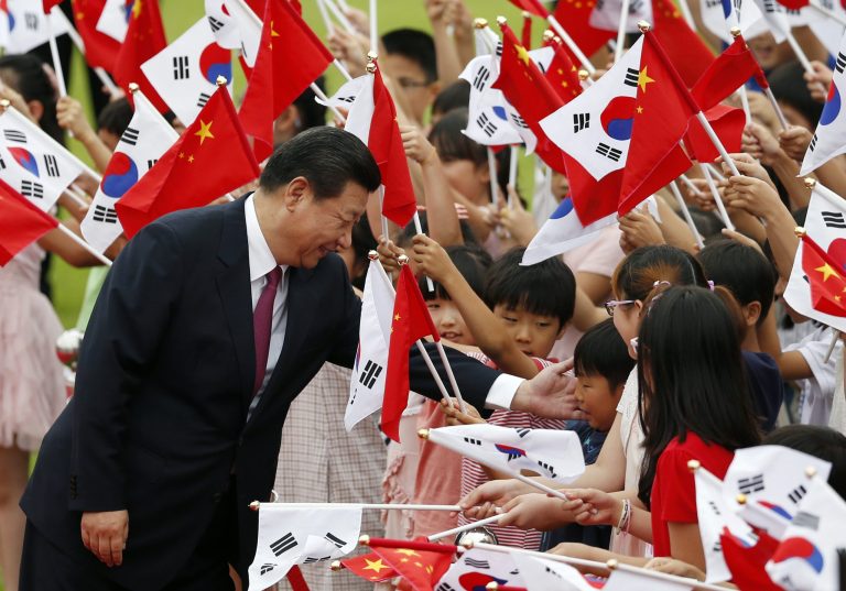 Chinese President Xi Jinping greets children during a welcome ceremony at the Presidential Blue House in Seoul, South Korea, Thursday, July 3, 2014. Xi's choice to meet with South Korean President Park Geun-hye over North Korean leader Kim Jong Un upends the practice since Beijing and Seoul forged diplomatic ties in 1992 of Chinese presidents choosing to make Pyongyang their first official destination on the Korean Peninsula. (AP Photo/Kim Hong-ji, Pool)