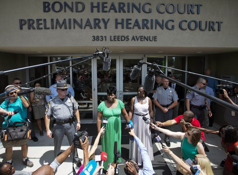 Nadine Collier, left, the daughter of Ethel Lance, one of the nine people killed in Wednesday's shooting at Emanuel AME Church, speaks to the media about her mother following the bond hearing for the suspected gunman Friday, June 19, 2015, in North Charleston, S.C. (AP Photo/David Goldman)