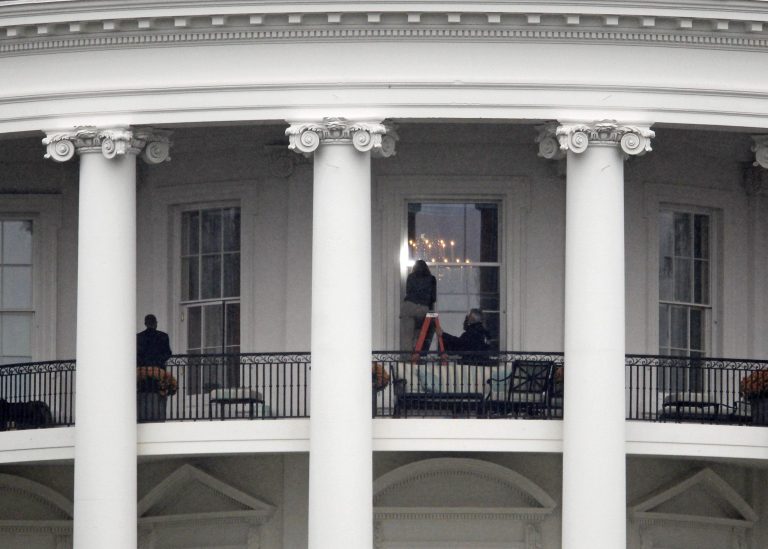 FILE - This Nov. 16, 2011 file photo shows law enforcement officers photographing a window at the White House in Washington, as seen from the South Lawn. A bullet hit an exterior window of the White House and was stopped by ballistic glass, the Secret Service said. An additional round of ammunition was found on the White House exterior. The bullets were found Tuesday morning.  An Idaho man who pleaded guilty to shooting at and hitting the White House is set to be sentenced.  Prosecutors say Oscar Ramiro Ortega-Hernandez should spend 27 years in prison for the 2011 shooting. His sentencing is scheduled for Monday afternoon. No one was injured, but prosecutors say Ortega-Hernandez hit the executive mansion about eight times and did nearly $100,000 in damage.  (AP Photo/Haraz N. Ghanbari, File)