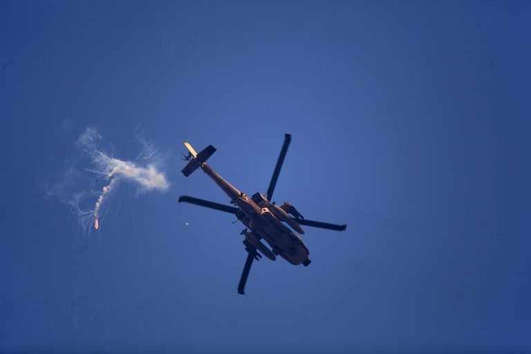 FILE - In this July 20, 2014 file photo, an Israeli attack helicopter shoots flares near the Israel and Gaza border. When Israel completes its damage assessment from its latest war with Hamas, it may conclude that one of the biggest casualties was its all-important relationship with the United States. (AP Photo/Dusan Vranic, File)