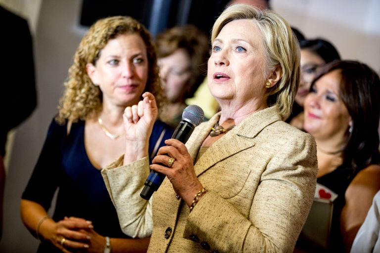 Rep. Debbie Wasserman Schultz, D-Fla., left, stands next to Democratic presidential candidate Hillary Clinton as she stops in to greet workers at a campaign office for Wasserman Schultz, in Davie, Fla., Tuesday, Aug. 9, 2016. A new report shows coordination between the DNC and Clinton to spread dirt on Team Trump. (AP Photo/Andrew Harnik)