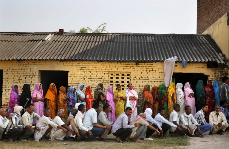 People wait in a queue to cast their votes at a polling station in Jaunpur, in the northern Indian state of Uttar Pradesh, India, Monday, May 12, 2014. Millions of Indian voters wrapped up a mammoth national election Monday, braving the searing sun on the final day of polling with the Hindu nationalist opposition candidate seen as the front-runner for prime minister. With 814 million eligible voters, India has been voting in phases over six weeks, with results expected on Friday. (AP Photo/Rajesh Kumar Singh)