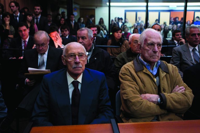 Former Argentina's dictators Jorge Rafael Videla, left, and Reynaldo Bignone wait to listen the verdict of Argentina's historic stolen babies trial in Buenos Aires, Argentina, Thursday, July 5, 2012. The two former dictators and a handful of other retired military and police officials are accused of systematically stealing babies from leftists who were kidnapped and killed when a military junta ran the country three decades ago. (AP Photo/Natacha Pisarenko)