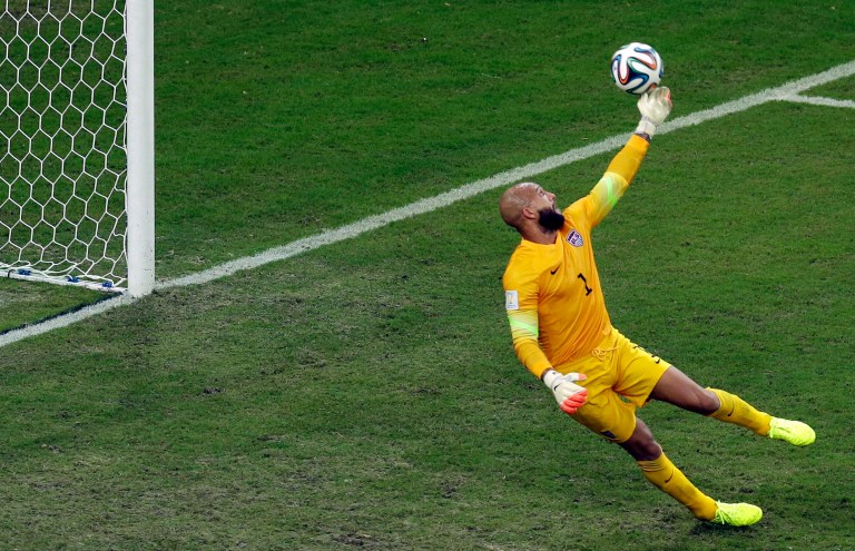 United States' goalkeeper Tim Howard tips a ball to deflect it over the goal during the group G World Cup soccer match between the USA and Portugal at the Arena da Amazonia in Manaus, Brazil, Sunday, June 22, 2014. (AP Photo/Themba Hadebe)