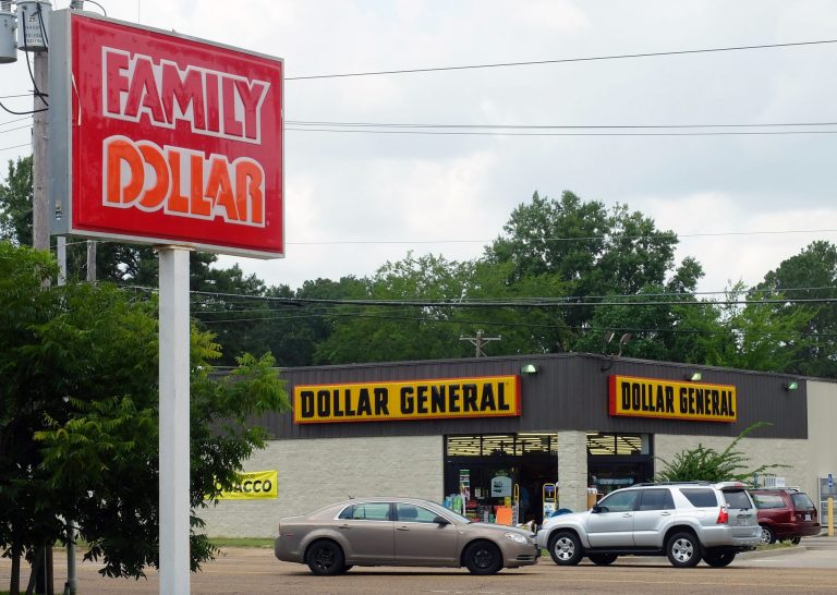 This Aug. 19, 2014 photo shows a Dollar General store across the street from a Family Dollar store in Jackson, Miss. Family Dollar on Wednesday, Sept. 17, 2014 recommended that its shareholders reject an unsolicited, $9.1 billion takeover bid taken directly to them by its rival, Dollar General. (AP Photo/Rogelio V. Solis)