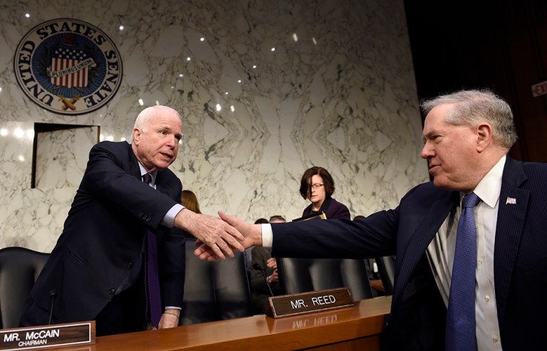 Sen. John McCain, R-Ariz., left, shakes hands with Defense Undersecretary Frank Kendall, the military's chief weapons buyer, right, before the start of a hearing on Capitol Hill on Russian-made rockets for military satellites. (AP Photo/Susan Walsh)