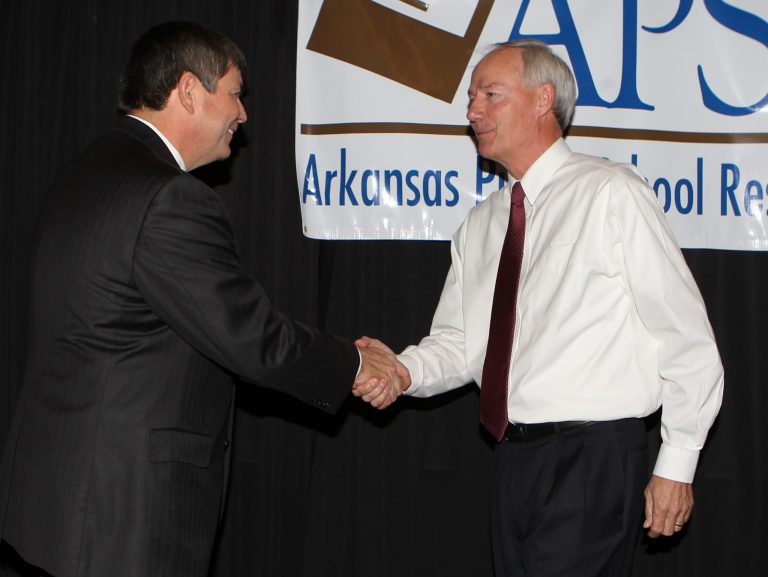 Former congressman and Democratic candidate for Arkansas governor Mike Ross, left, and former congressman and Republican hopeful for governor Asa Hutchinson shake hands following a panel discussion on education at the Arkansas Public School Resource Center Fall Conference at Hot Springs Convention Center in Hot Springs, Ark., Tuesday, Nov. 12, 2013. (AP PHOTO/The Sentinel-Record, Richard Rasmussen)