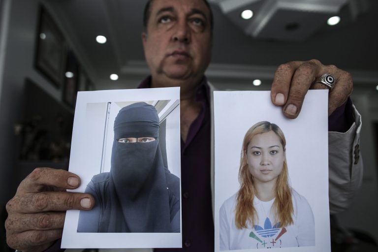 Car salesman Sahin Aktan shows photos of his ex-wife Asiya Ummi Abdullah as he
speaks during an interview at his lawyer's office in Istanbul, Turkey, Friday, Sept. 19, 2014. The 44-year-old is the ex-husband of Asiya Ummi Abdullah, a 24-year-old Muslim convert who took their child to the territory controlled by Islamic State. Her experience illustrates the puritanical pull of the Islamic State group, the self-styled caliphate straddling Iraq and Syria that has sent shockwaves around the world with its bloodthirsty campaign. It also shows how, even in Turkey _ one of the most modern and prosperous of the Muslim countries _ entire families are dropping everything to find salvation in what one academic describes as a âfalse heaven.â (AP Photo/Emrah Gurel)