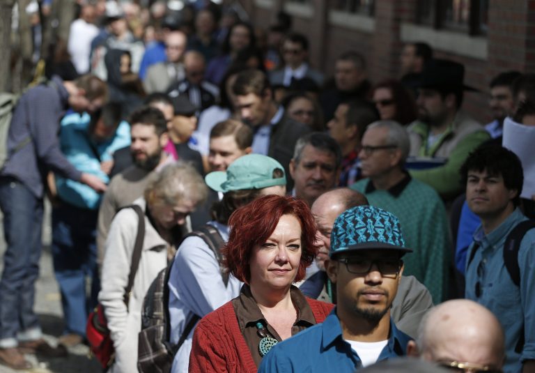 FILE - In this Thursday March 13, 2014, file photo, job seekers line up to attend a marijuana industry job far in Downtown Denver. The government issues the March jobs report on Friday, April 4, 2014. (AP Photo/Brennan Linsley, File)