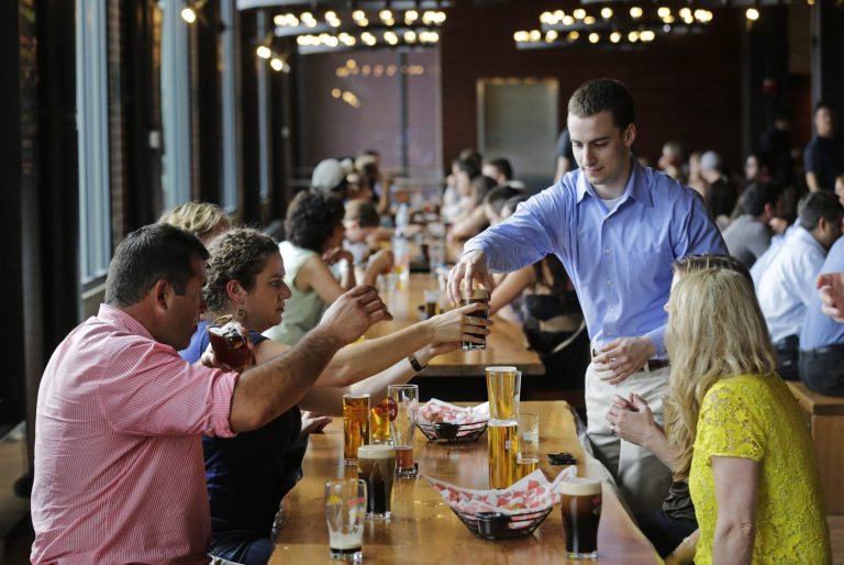   FILE - In this July 1, 2013 file photo, patrons sample a variety of beers at the Beer Hall at the Harpoon Brewery in the Seaport District of Boston. US service firms expanded in July at the fastest pace since February, fueled by a jump in new orders and stronger business activity. AP Photo/Charles Krupa, File)  