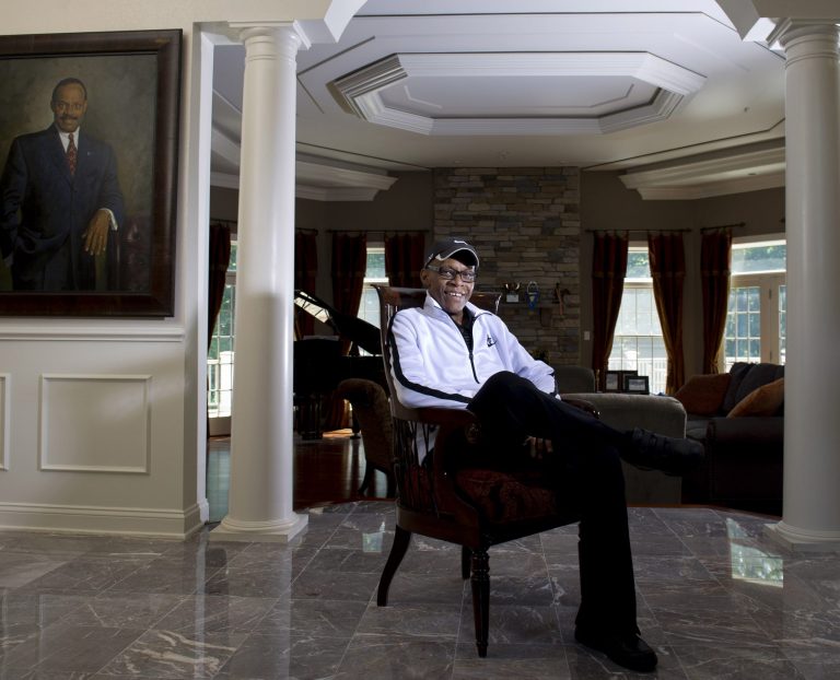 In this May 22, 2014, photo, former Prince George's County Executive Wayne K. Curry poses for a portrait at his home in Upper Marlboro, Md.  A portrait of Curry is seen to the left on the wall. Curry, 63, has died at his home, of lung cancer. Democratic Gov. Martin O'Malley said in a statement Wednesday, July 2, 2014, that Curry oversaw a 