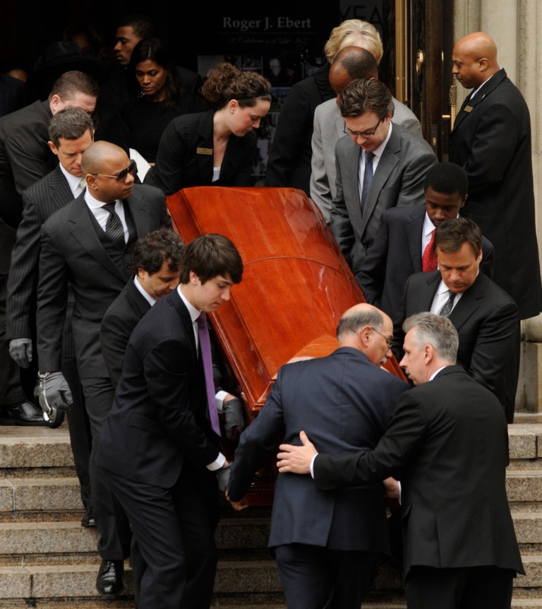 Pallbearers carry the casket of film critic Roger Ebert after his funeral at Holy Name Cathedral in Chicago, April 8, 2013. The Pulitzer Prize-winning movie reviewer died Thursday, April 4 at age 70 after a long battle with cancer. (AP Photo/Paul Beaty)