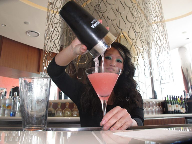 In this April 8, 2013 photo, Mary Ma, a bartender at Revel Casino Hotel, pours a peach-flavored drink at the hotel, in Atlantic City, N.J. Atlantic City is increasing efforts to promote its nightlife, with luxury bus tours bringing Philadelphia partiers to Atlantic City, promotions aimed at bachelor and bachelorette parties, and summer-themed activities during the slow winter period. (AP Photo/Wayne Parry)