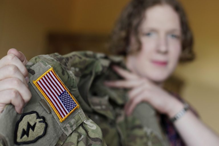 Transgender U.S. army captain Jennifer Sims lifts her uniform during an interview with the Associated Press in Beratzhausen near Regensburg, Germany, on June 29. The legal battle over President Trump's effort to roll back the Obama administration policy of open transgender service may just be getting underway. 
