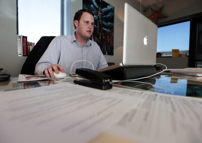 Jeremy Bills works at his job as associate director at the Nashville Education Community and Arts Television office on Wednesday, Nov. 13, 2013, in Nashville, Tenn. Bills, originally from Tampa, Fla., received his master's degree from Vanderbilt University in Nashville and has stayed in his college town while trying unsuccessfully to find a job in his field of study. After initial signs of recovery, U.S. mobility for young adults has fallen to the lowest level in more than 50 years. Cash-strapped 20-somethings are shunning home-buying and refraining from major moves in the weak job market. (AP Photo/Mark Humphrey)