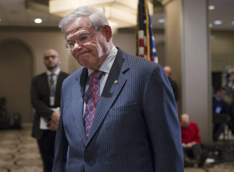 Sen. Bob Menendez, D-N.J., leaves after news conference in Newark, N.J. on Friday, March 6, 2015. (AP Photo/John Minchillo)