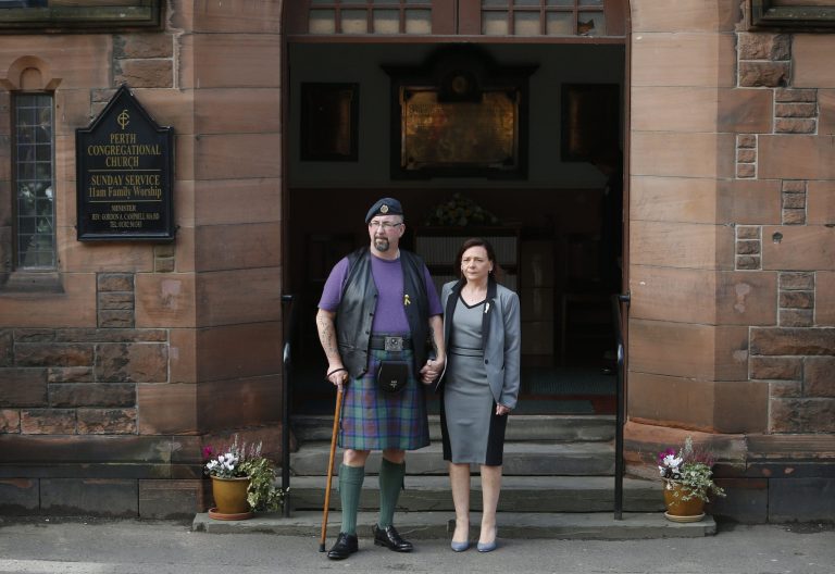 Barbara Henning, the widow of Alan Henning,  stands with Michael Haines, the brother of David Haines, the two British aid workers killed by Islamic  State group militants, outside the Perth Congregational Church in Perth Scotland Saturday Oct. 18, 2014   prior to a memorial service for David Haines.  Families of  the two British aid workers killed by the Islamic State group in Syria have urged people of all faiths to unite against the militants' 