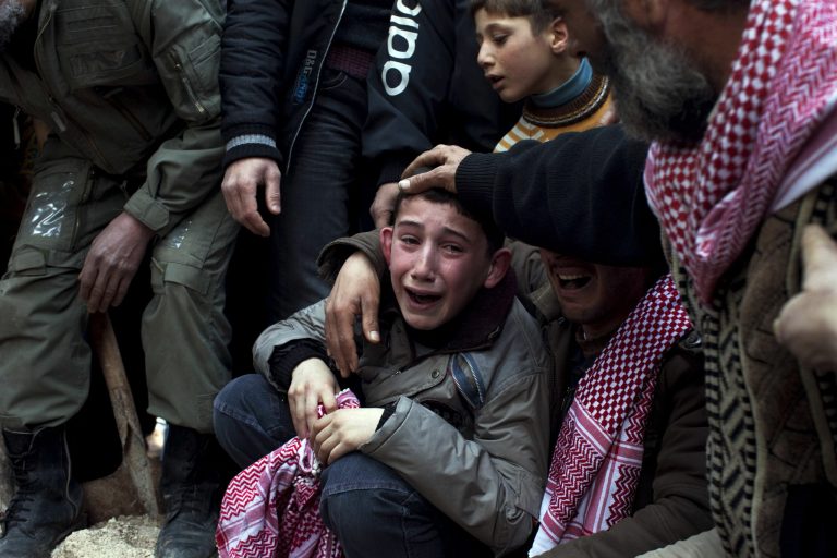 A boy mourns his father, Abdulaziz Abu Ahmed Khrer, who was killed by a Syrian Army sniper, during his funeral in Idlib, northern Syria, in March 2012. (AP Photo/Rodrigo Abd, File)