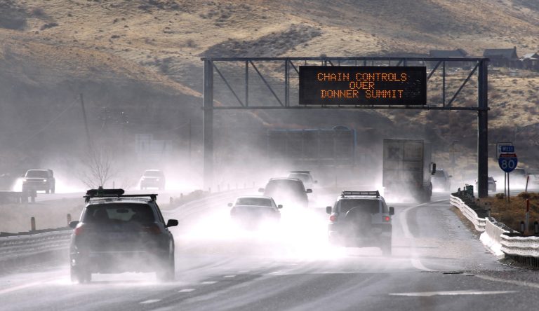   Traffic moves west along Interstate 80 west of Reno, Nev., as a heavy, wet storm hits Northern Nevada on Sunday, Dec. 2, 2012. A powerful storm delivered more snow and less rainfall Sunday to the Sierra than forecast, blunting the flooding danger on the Truckee River in California and Nevada, forecasters said. (AP Photo/Cathleen Allison)  