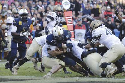 Rob Carr/Getty Images
Kriss Proctor completed just one pass but rushed for 97 yards and two touchdowns on 32 carries as Navy beat Army.