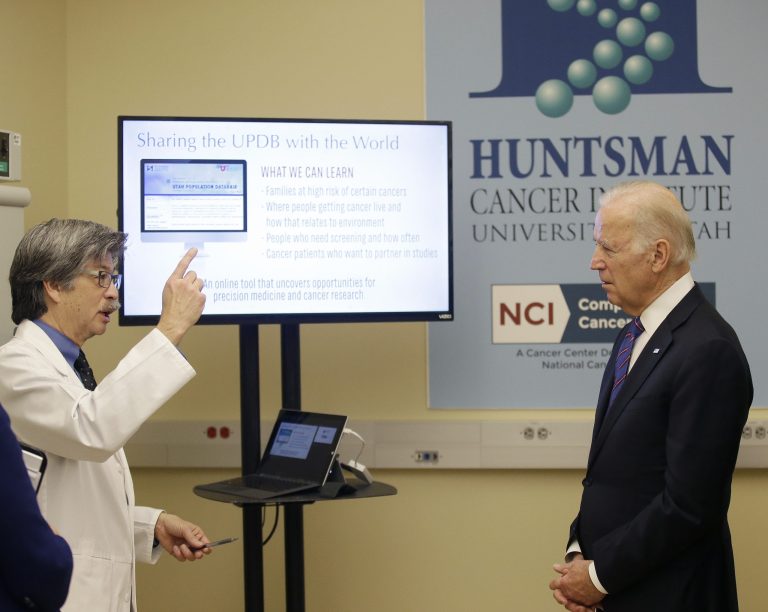 Dr. Ken Smith speaks with Vice President Joe Biden during a tour of the research lab at the Huntsman Cancer Institute on Feb. 26 in Salt Lake City as part of the White House's cancer 