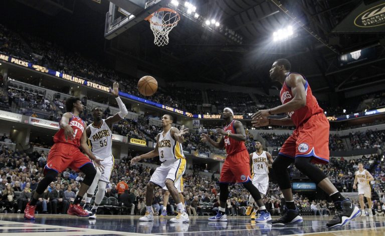   Philadelphia 76ers' Nick Young (1) passes to teammate Thaddeus Young, right, as Indiana Pacers' Roy Hibbert (55) and George Hill (3) watch during the first half of an NBA basketball game on Friday, Dec. 14, 2012, in Indianapolis. (AP Photo/Darron Cummings)  