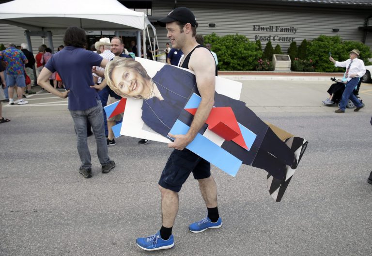 John West, of Chicago, carries a cardboard cutout of Democratic presidential candidate Hillary Rodham Clinton outside a rally, Sunday, June 14, 2015, in Des Moines, Iowa. (AP Photo)Â 
