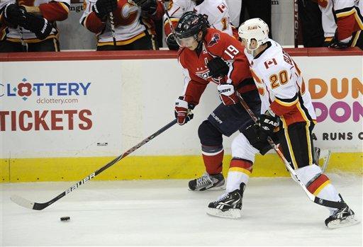 Calgary Flames left wing Curtis Glencross (20) battles for the puck against Washington Capitals center Nicklas Backstrom (19), of Sweden, during the third period of an NHL hockey game, Tuesday, Jan. 3, 2012, in Washington. The Capitals won 3-1. 
