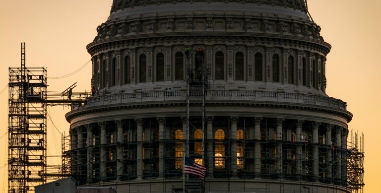 A construction worker carries a ladder across the scaffolding on the U.S. Capitol Dome early in the morning, Tuesday, Sept. 6, 2016, in Washington on the day Congress returns to work after their summer holiday. (AP Photo/J. David Ake)