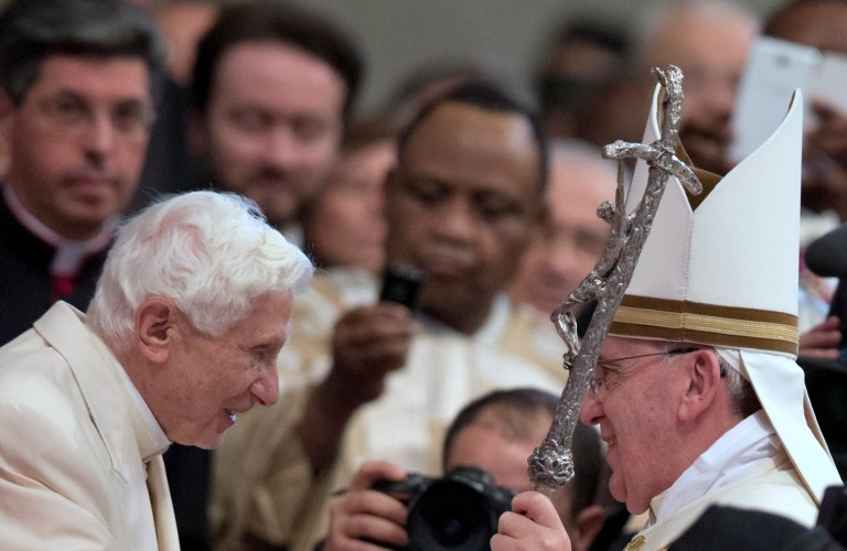 Pope Emeritus Benedict XVI  is greeted by Pope Francis at the end of a consistory inside the St. Peter's Basilica at the Vatican, Saturday, Feb. 22, 2014. Benedict XVI has joined Pope Francis in a ceremony creating the cardinals who will elect their successor in an unprecedented blending of papacies past, present and future. (AP Photo/Alessandra Tarantino)