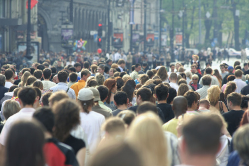 Crowd of people walking on city