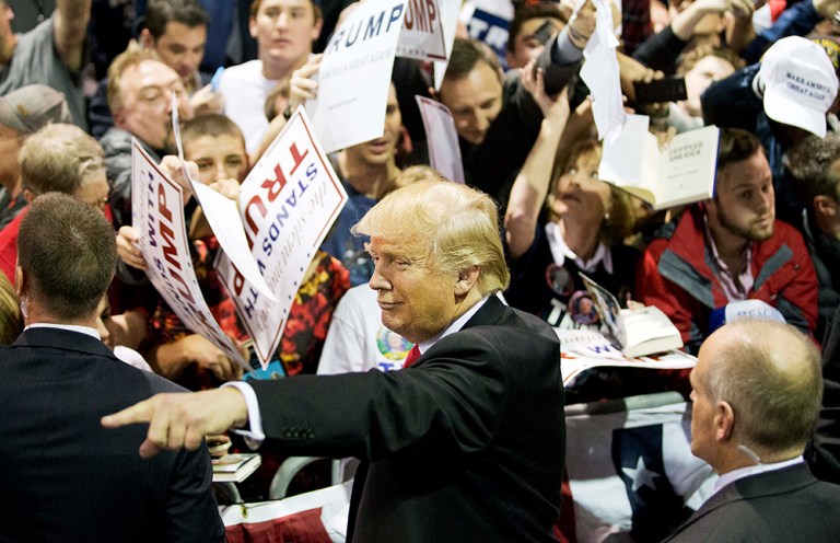 Republican presidential candidate Donald Trump gestures as signs autographs at a campaign event Sunday, Feb. 21, 2016, in Atlanta. (AP Photo/David Goldman)