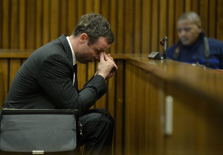 Oscar Pistorius, gestures, as he sits in court, during his trial in Pretoria, South Africa, Friday, Aug. 8, 2014. The chief defense lawyer for Oscar Pistorius delivered final arguments in the athlete's murder trial on Friday, alleging that Pistorius thought he was in danger when he killed girlfriend Reeva Steenkamp and also that police mishandled evidence at the house where the shooting happened.(AP Photo/Herman Verwey, Pool)