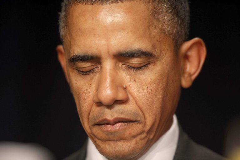 President Barack Obama closes his eyes as a prayer is offered at the National Prayer Breakfast in Washington, Thursday, Feb. 6, 2014. (AP Photo/Charles Dharapak)