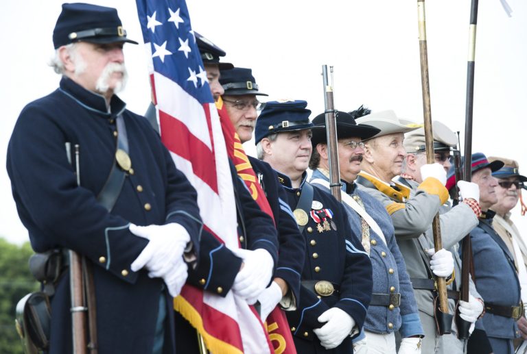 A group of reenactors portraying Union and Confederate soldiers stand during the opening ceremony commemorating the 150th anniversary of the Battle of Monocacy, the only major Confederate victory on northern soil, Wednesday, July 9, 2014, at the Monocacy National Battlefield near Fredrick, Md. (AP Photo/The Frederick News-Post, Graham Cullen)