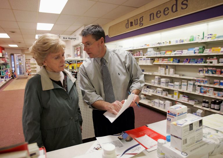 Pharmacist, William Hewitt, (R) speaks with Aase Kjos-Hansen about her options under the new Medicare prescription drug benefit program at Rosemont Pharmacy January 18, 2006 in Portland, Maine. (Photo by Joe Raedle/Getty Images)