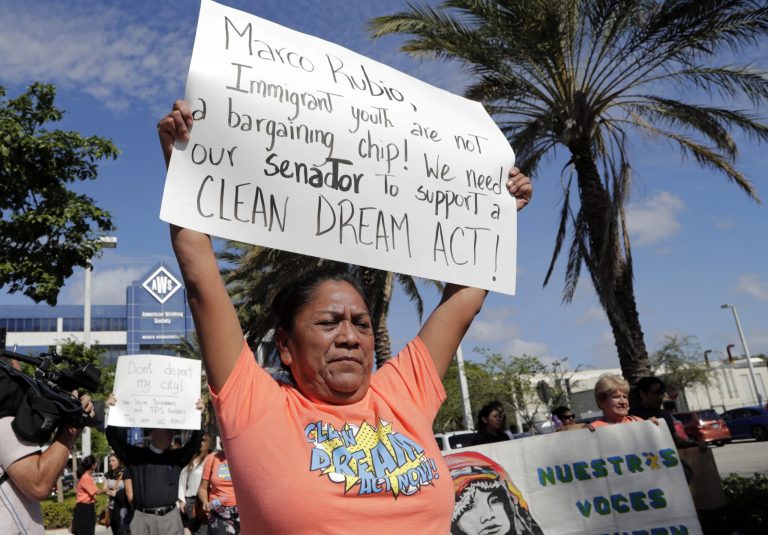 Antonia Catalan marches outside of the office of Sen. Marco Rubio, R-Fla., in support of Deferred Action for Childhood Arrivals (DACA), and Congress passing a clean Dream Act, Monday, Jan. 22, 2018, in Doral, Fla. (AP Photo/Lynne Sladky)