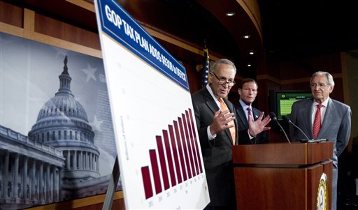From left: Sen. Charles Schumer, D-N.Y., with Sen. Richard Blumenthal, D-Conn., and Sen. Tom Harkin, D-Iowa, talk about the Democrats and Republican tax proposals during a news conference on Capitol Hill in Washington Tuesday, July 24, 2012.  (AP Photo/Manuel Balce Ceneta)