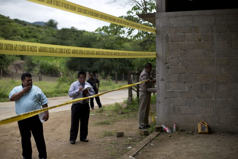 FILE - In this July 3, 2014 file photo, state authorities use crime scene tape to seal off an unfinished warehouse that was the site of a shootout between Mexican soldiers and alleged criminals on the outskirts of the village of San Pedro Limon in Mexico state, Mexico. Three soldiers have been charged with homicide in the June killings of 22 suspected gang members in southern Mexico, Attorney General Jesus Murillo Karam announced on Tuesday Sept. 30 2014. (AP Photo/Rebecca Blackwell, File)