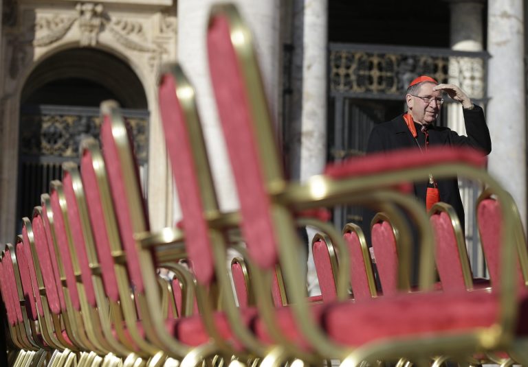 Cardinal Roger Mahony stands next to a row of chairs in St. Peter's Square at the Vatican, Wednesday, Feb. 27, 2013. Pope Benedict XVI is preparing for his final general audience, the weekly appointment he kept with the faithful and tourists to teach them about the Catholic faith. (AP Photo/Gregorio Borgia)