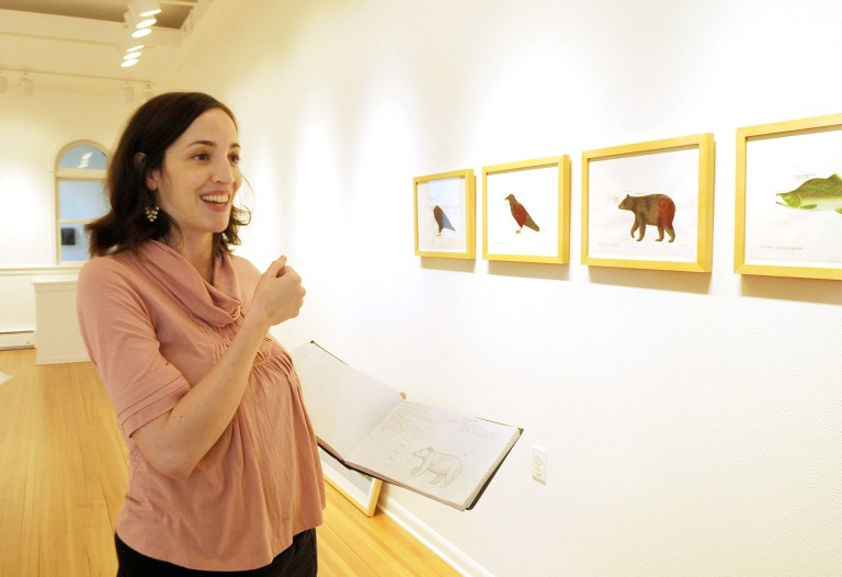   Artist Jenny Kane, holding a sketch book, talks about her new show 